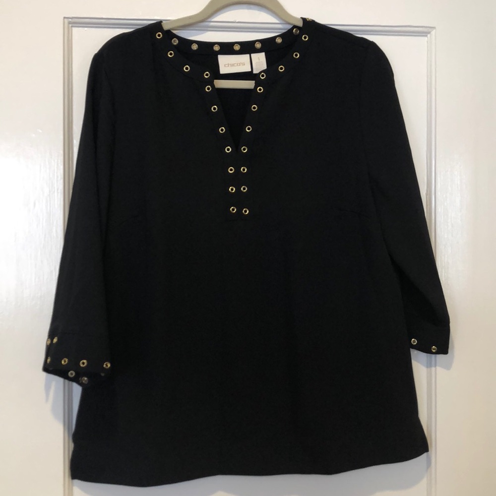 Black split neck top with gold grommet detail
